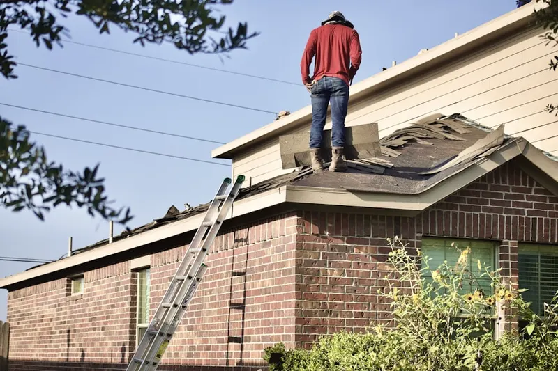 Professional roofer working on a residential roof in West Bellevue